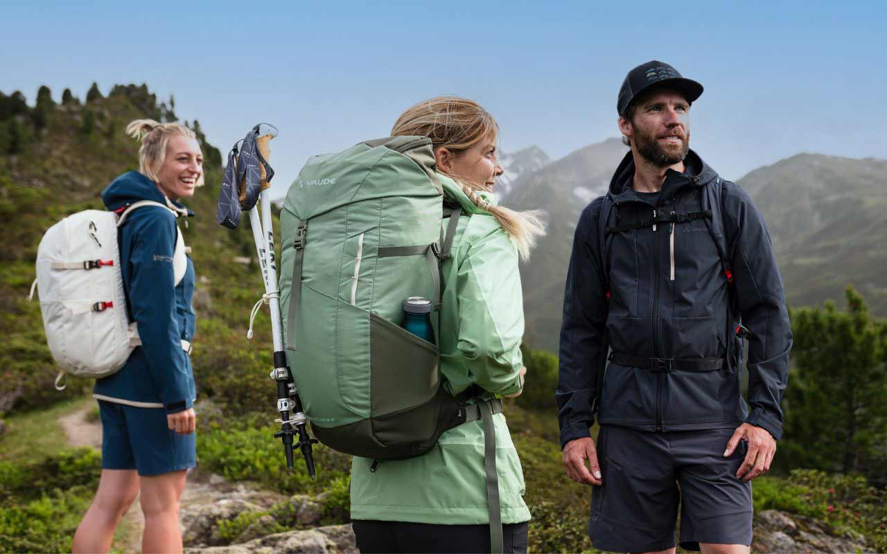 Three people with rucksacks in the mountains