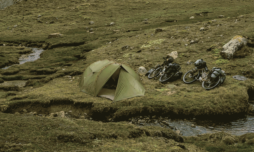 Tenten in het avondlicht en in een bergweide