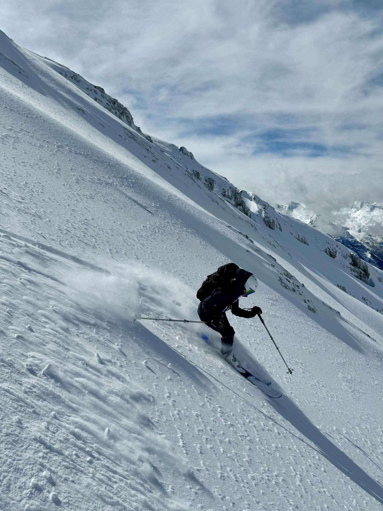 Person fährt mit Ski durch Pulverschnee.