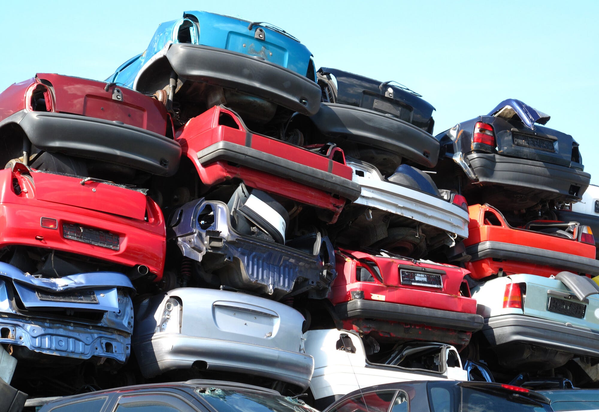 stacked cars at the junkyard