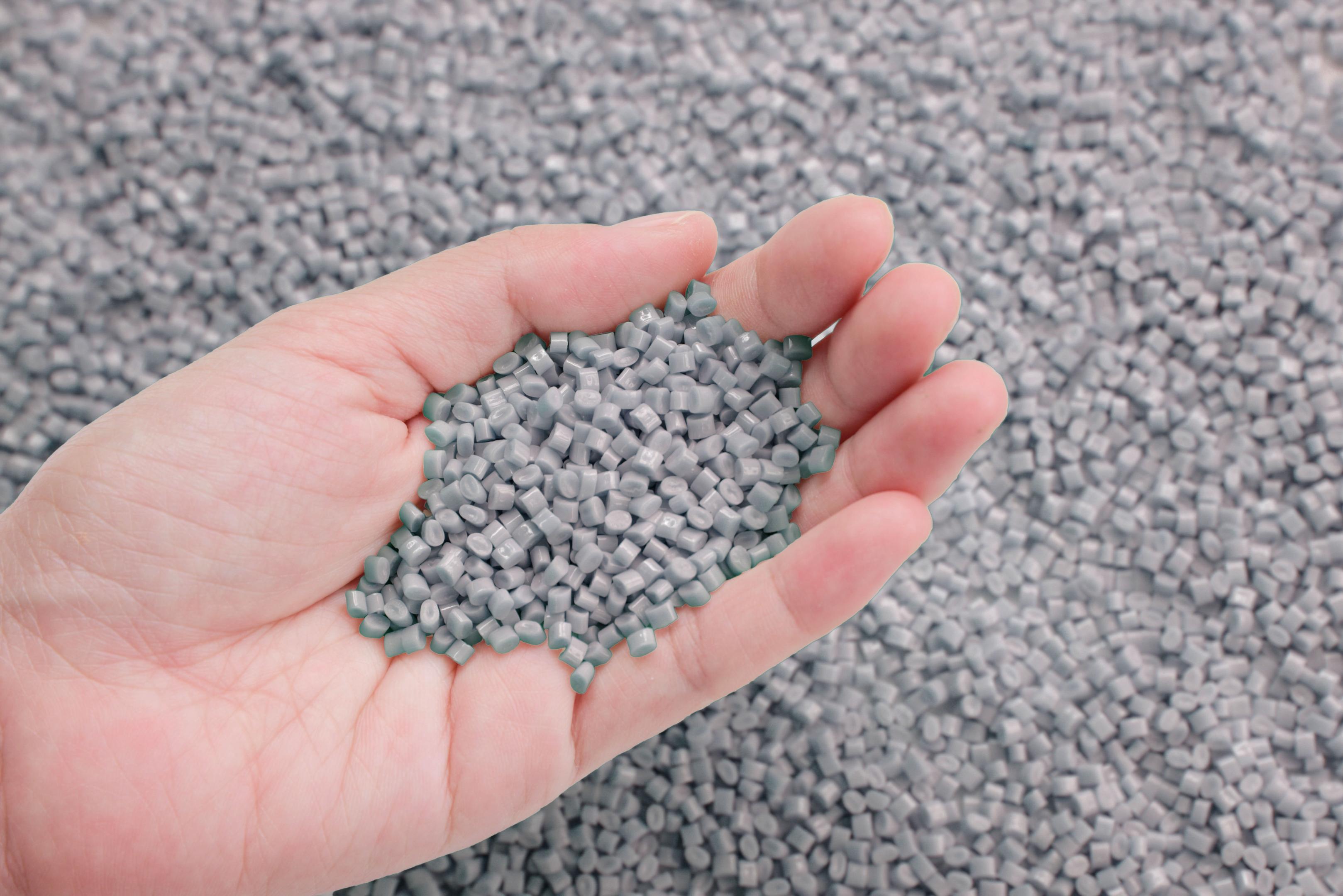 Hand full of plastic granules